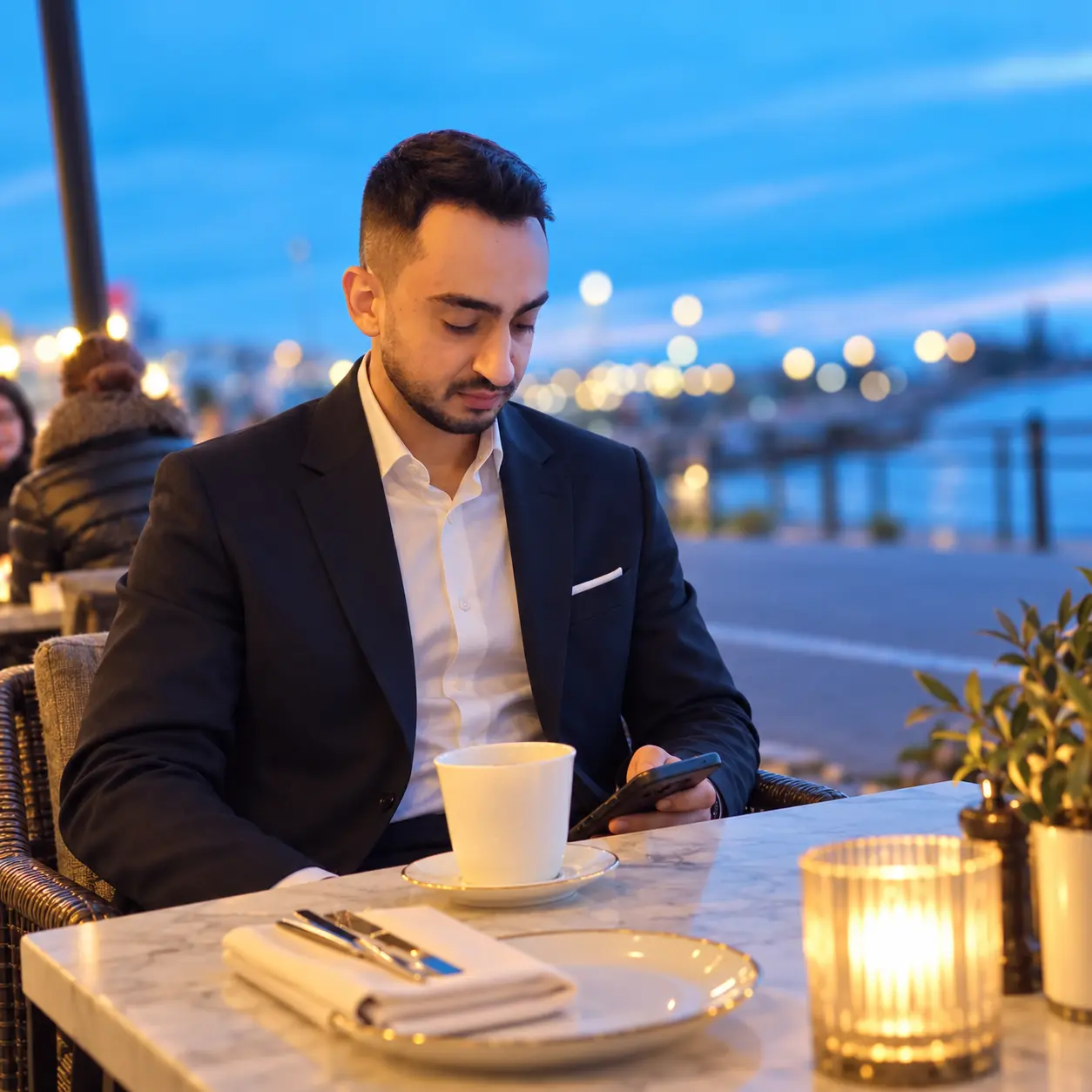 Ahmad Foroughi seated at a café table.